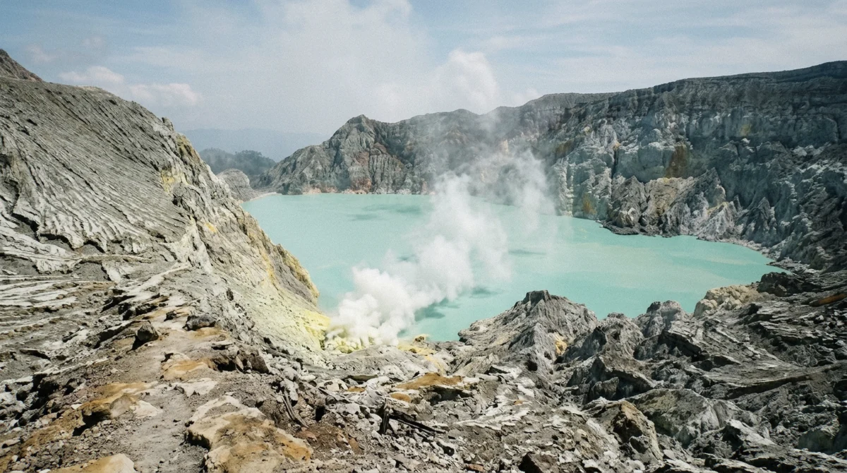 Turquoise acidic crater lake at Mount Ijen viewed from the sunrise rim, the payoff that makes the Mount Ijen hike worth it